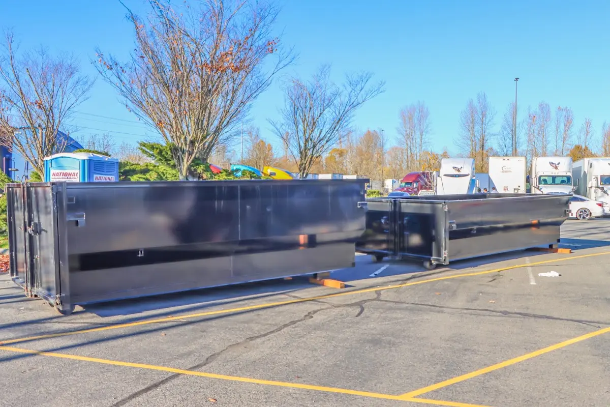 Professional dumpster rental service with roll-off container on residential driveway in Culver City